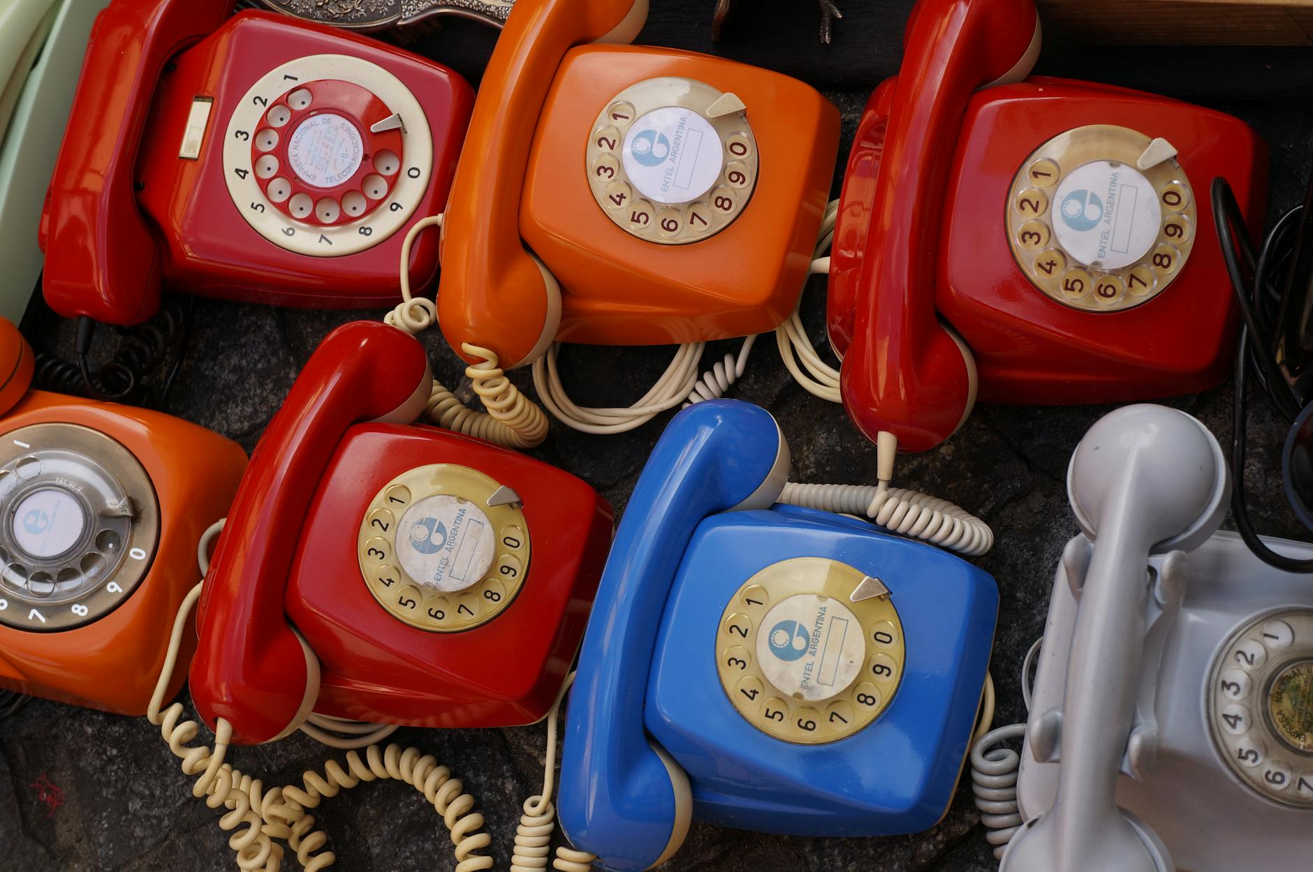 A collection of colorful vintage rotary telephones evokes nostalgic charm and retro style.